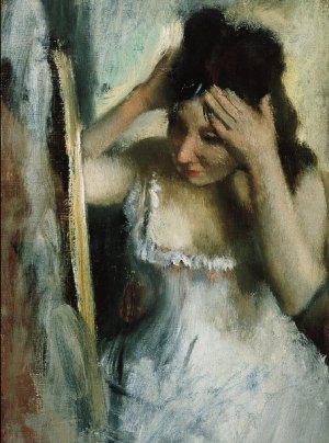 Photo de Woman Combing her Hair before a Mirror