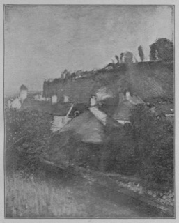 Maisons au pied d'une falaise.